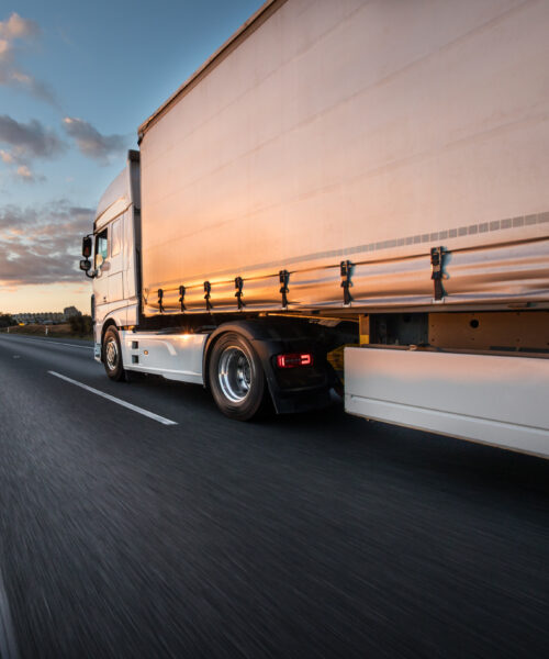 Truck with container on highway, cargo transportation concept. Shaving effect.