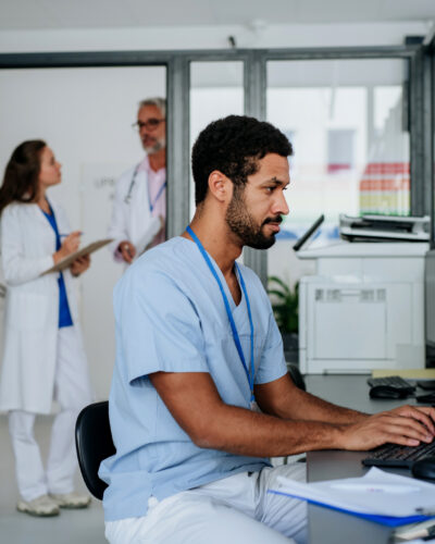 Young doctor working on computer in the hospital office.