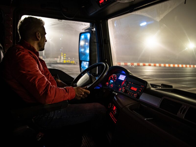 The driver at the wheel of the truck. The driver at the wheel of the truck. Night course.