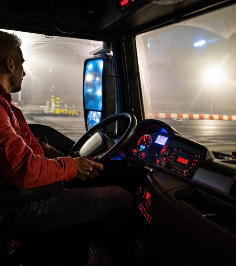 The driver at the wheel of the truck. Night course.