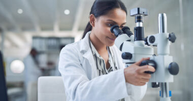 A Doctor Using Medical Equipment In A Lab