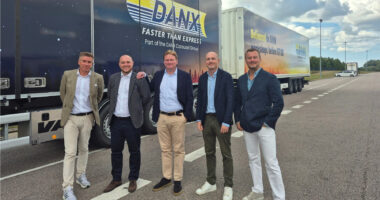 DANX And BMW Northern Europe Representatives In Front Of Branded DANX Vehicles At The Staffanstorp Distribution Centre